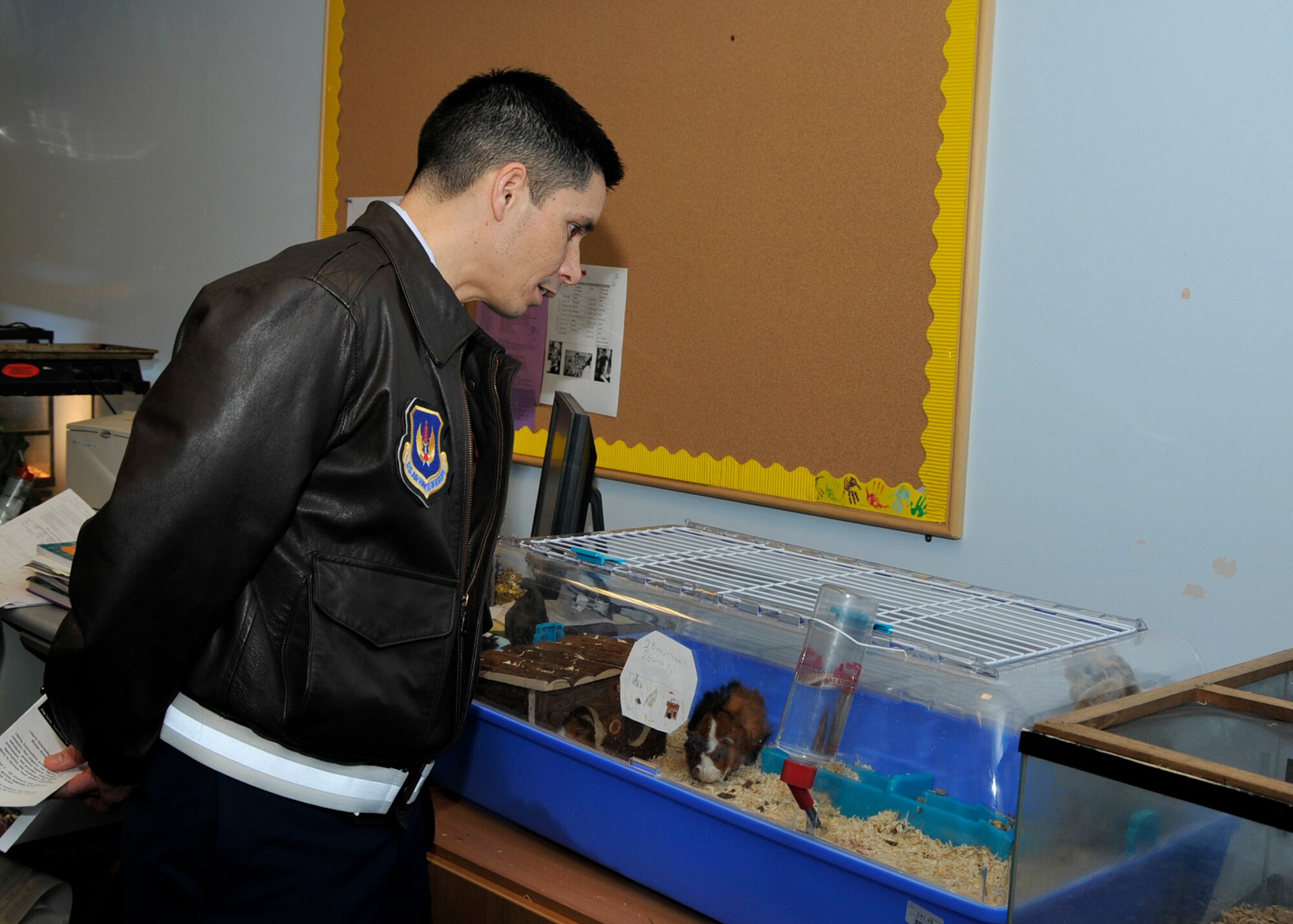 ROYAL AIR FORCE LAKENHEATH, England – 48th Fighter Wing Commander Col. John Quintas looks at guinea pigs and rabbits in a classroom at the Lakenheath Intermediate School during a visit on Nov. 8. (U.S. Air Force photo/Airman 1st Class Tiffany M. Deuel)
