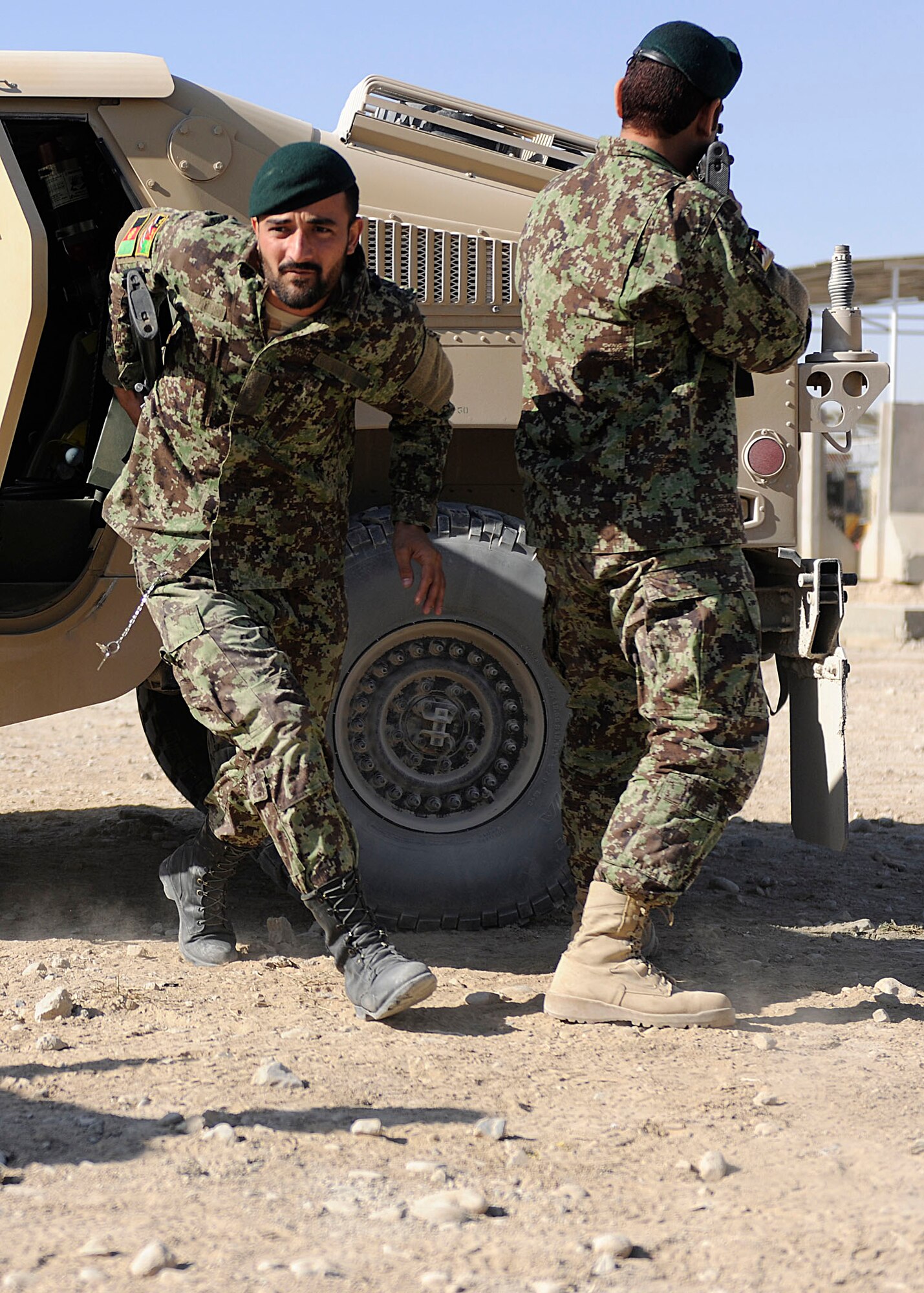 KANDAHAR AIRFIELD, Afghanistan - A member of the Afghan Air Force Kandahar Air Wing Security Kandak exits a Humvee during a training session at Kandahar Airfield, Afghanistan, Nov. 7. The soldiers practiced their Humvee driving skills and dismount procedures after attending a month-long training session taught by the U.S. Air Force’s 443rd Air Expeditionary Advisory Squadron members. (U.S. Air Force photo by Senior Airman John D. Strong II / 16th Mobile Public Affairs Detachment)