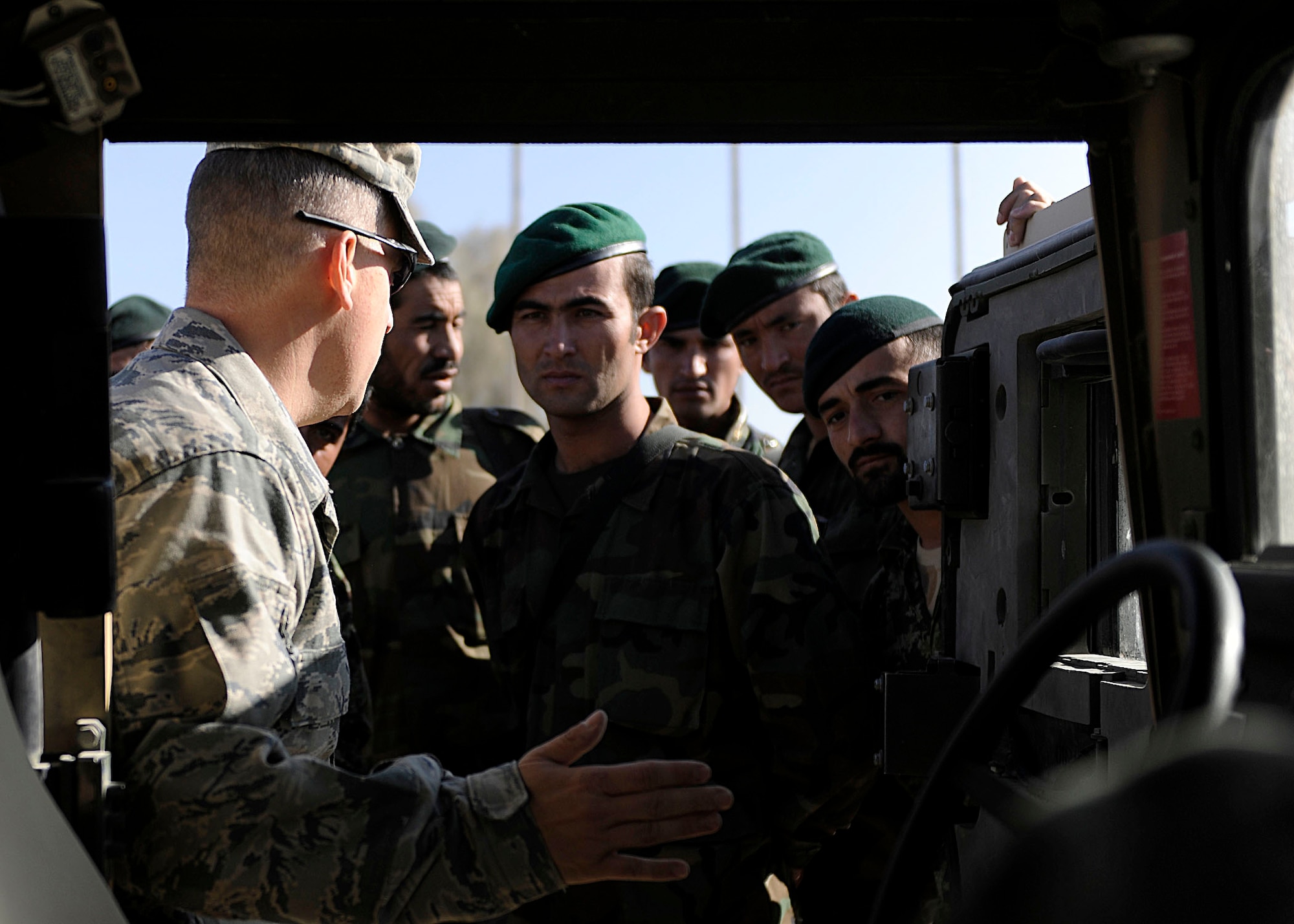 KANDAHAR AIRFIELD, Afghanistan -  U.S. Air Force Tech. Sgt. Michael Smith, 443rd Air Expeditionary Advisory Squadron/NATO Training Mission - Afghanistan, instructs a group of Afghan Air Force members during a training session at Kandahar Airfield, Afghanistan, Nov. 7. The AAF members belong to the Kandahar Air Wing Security Kandak and are training to become an elite quick-response force. (U.S. Air Force photo by Senior Airman John D. Strong II / 16th Mobile Public Affairs Detachment)