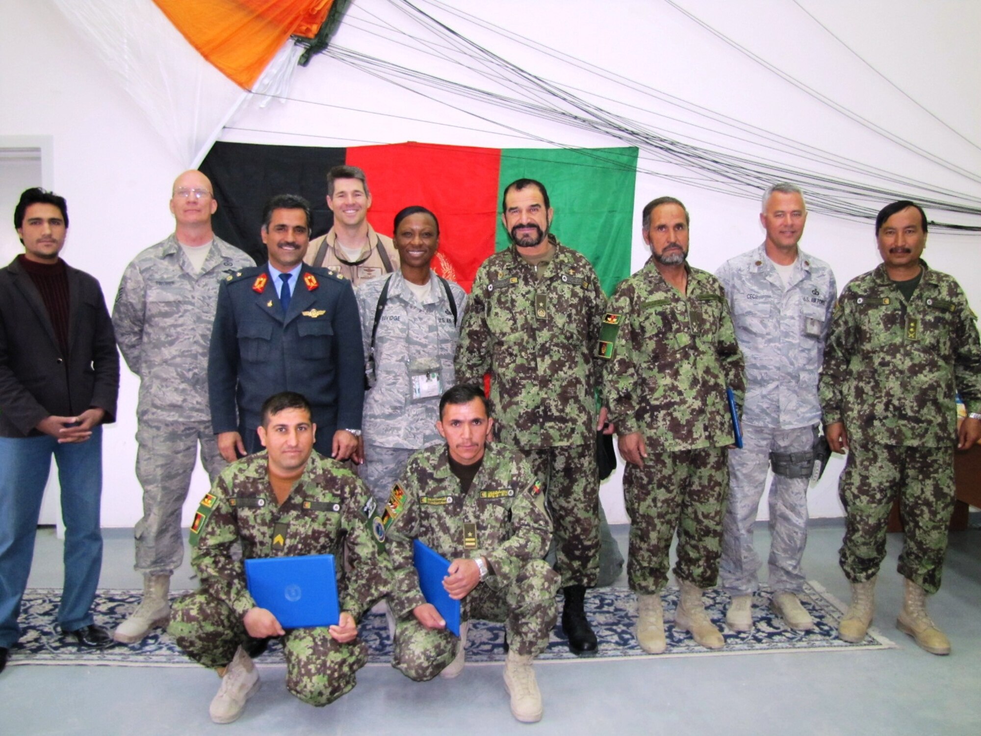 KABUL, Afghanistan - Members of the Afghan Air Force Life Support celebrate with senior leaders after their graduation when they became the first AAF riggers on Nov 10.  (U.S. Air Force photo by Capt. Rob Leese/RELEASED).
