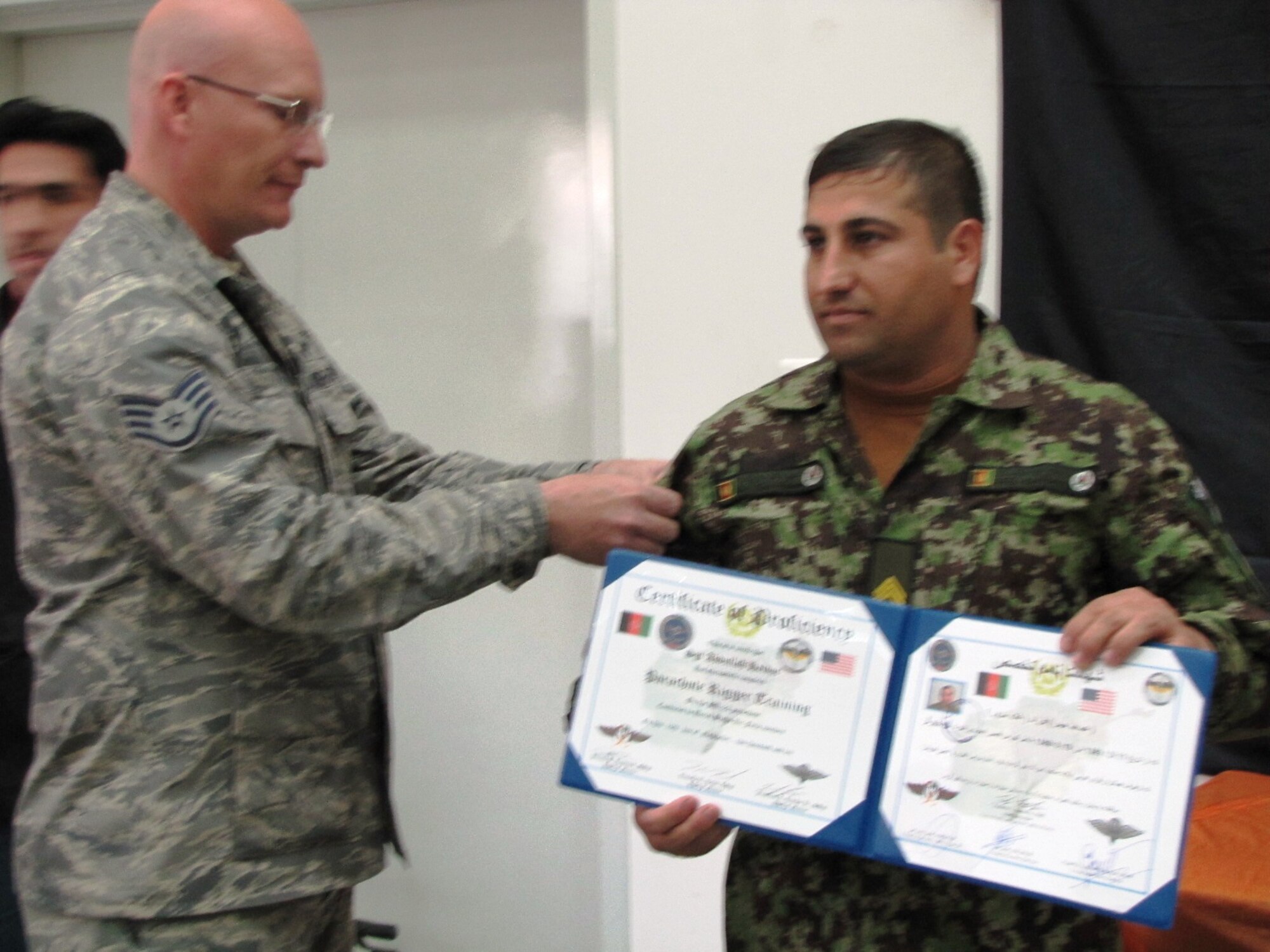 KABUL, Afghanistan - Members of the Afghan Air Force Life Support flight graduate after passing all test to earn their certificates and become the first AAF riggers on Nov 10.  (U.S. Air Force photo by Capt. Rob Leese/RELEASED).

