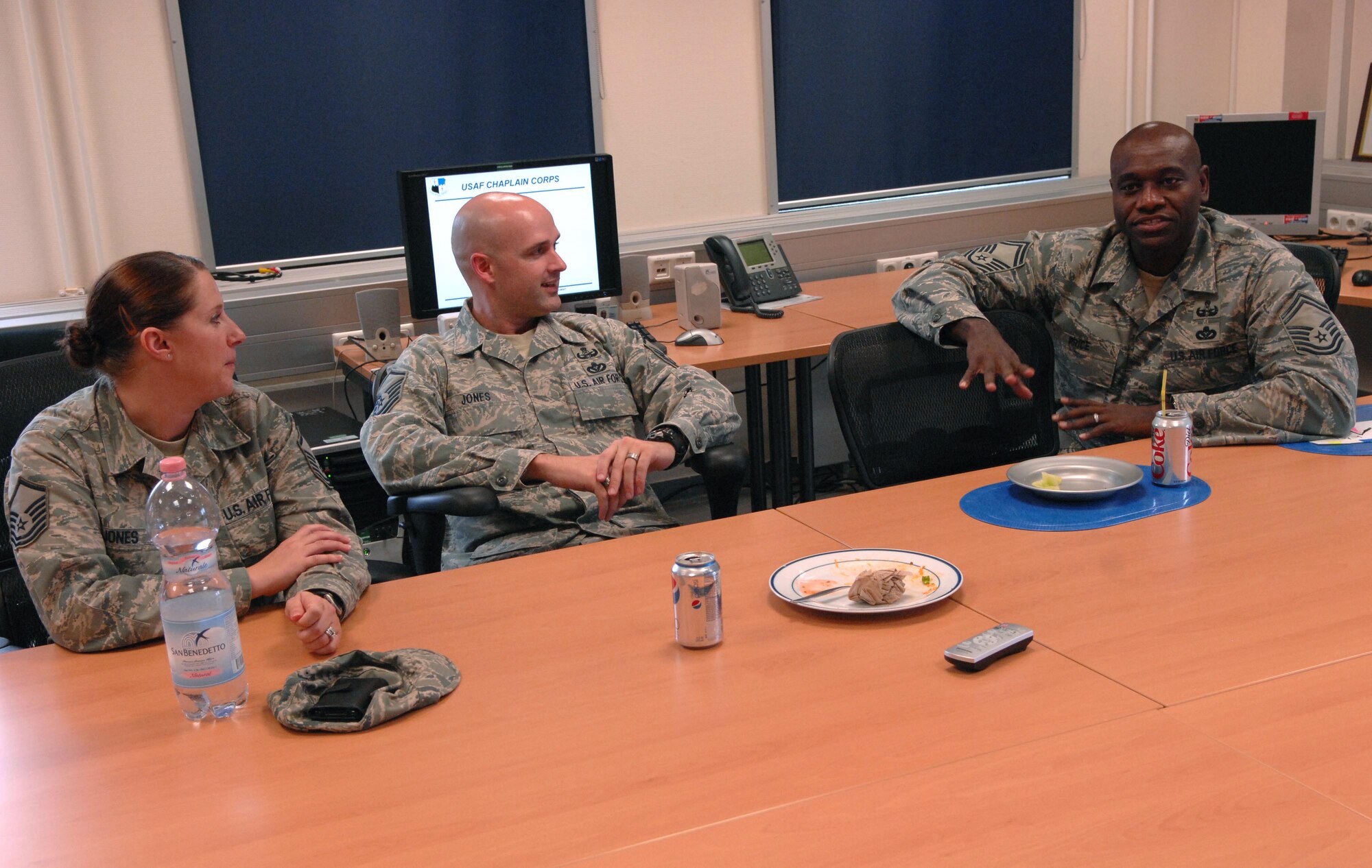 SPANGDAHLEM AIR BASE, Germany – Senior Master Sgt. George Price, right, 52nd Civil Engineer Squadron explosive ordnance NCO in charge, Master Sgt. Neil Jones, 52nd CES explosive ordnance technician, and his wife, Master Sgt. Lisabeth Jones, 52nd Medical Operations Squadron, talk after eating lunch at the explosive ordnance flight safety day Nov. 5. The activities were intended to raise awareness about the dangers of the career field and how to deal with the stress associated with it. (U.S. Air Force photo/Airman 1st Class Matthew B. Fredericks)