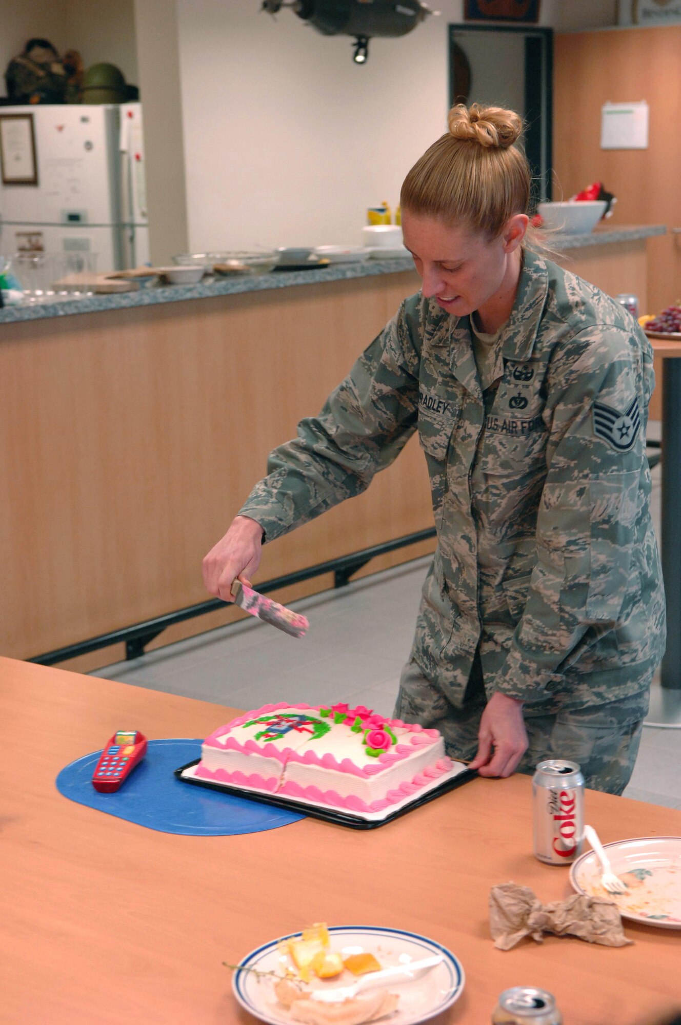 SPANGDAHLEM AIR BASE, Germany – Staff Sgt. Elizabeth Spradley, 52nd Civil Engineer Squadron explosive ordnance technician, serves cake at the explosive ordnance flight safety day Nov. 5. The activities were intended to raise awareness about the dangers of the career field and how to deal with the stress associated with it. (U.S. Air Force photo/Airman 1st Class Matthew B. Fredericks)