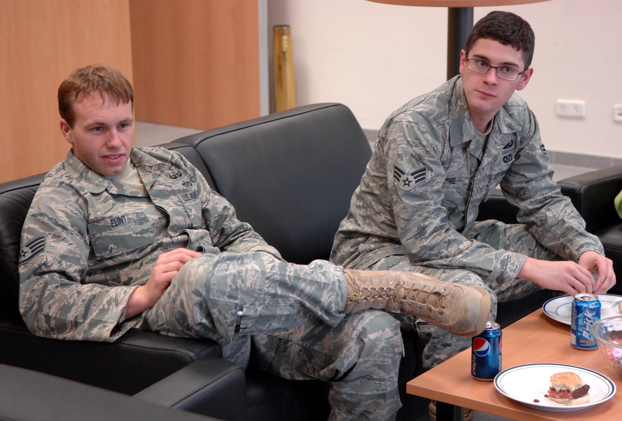 SPANGDAHLEM AIR BASE, Germany – Staff Sgt. Brock Flint, left, and Airman 1st Class Jerimiah Bethel, 52nd Civil Engineer Squadron explosive ordnance technicians, relax after eating lunch during the explosive ordnance flight safety day Nov. 5. The activities were intended to raise awareness about the dangers of the career field and how to deal with the stress associated with it. (U.S. Air Force photo/Airman 1st Class Matthew B. Fredericks)