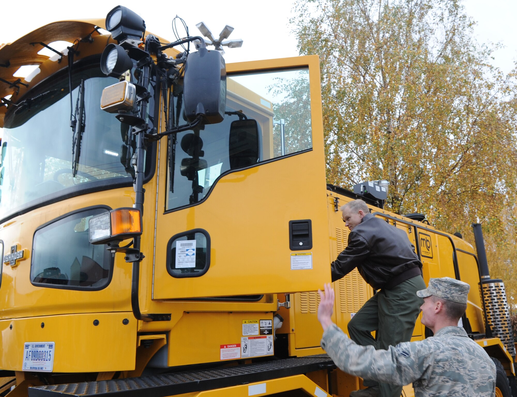SPANGDAHLEM AIR BASE, Germany – Col. Chris Weggeman, 52nd Fighter Wing commander, climbs onto a ribbon blower as Airman 1st Class Addison Clemens, 52nd Civil Engineer Squadron pavements and equipment apprentice, opens the door during a snow removal demonstration Nov. 5. Colonel Weggeman and other members of wing leadership attended the event to learn about snow removal equipment and operations on base. (U.S. Air Force photo/Senior Airman Nick Wilson)