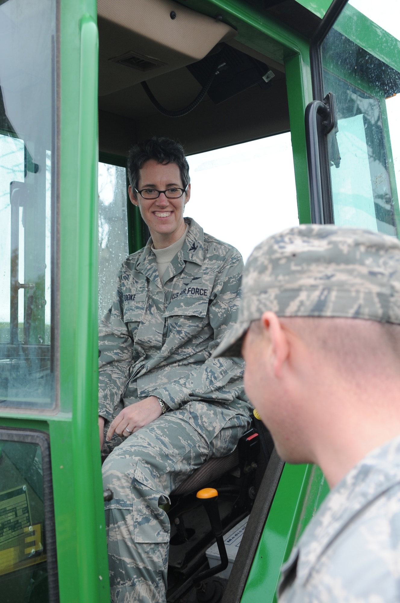 SPANGDAHLEM AIR BASE, Germany – Col. Jodine Tooke, 52nd Mission Support Group commander, speaks to Senior Airman Joseph Chalkley, 52nd Civil Engineer Squadron pavements and equipment journeyman, during a snow removal demonstration Nov. 5. Colonel Tooke and other members of wing leadership attended the event to learn about snow removal equipment operations on base. (U.S. Air Force photo/Senior Airman Nick Wilson)