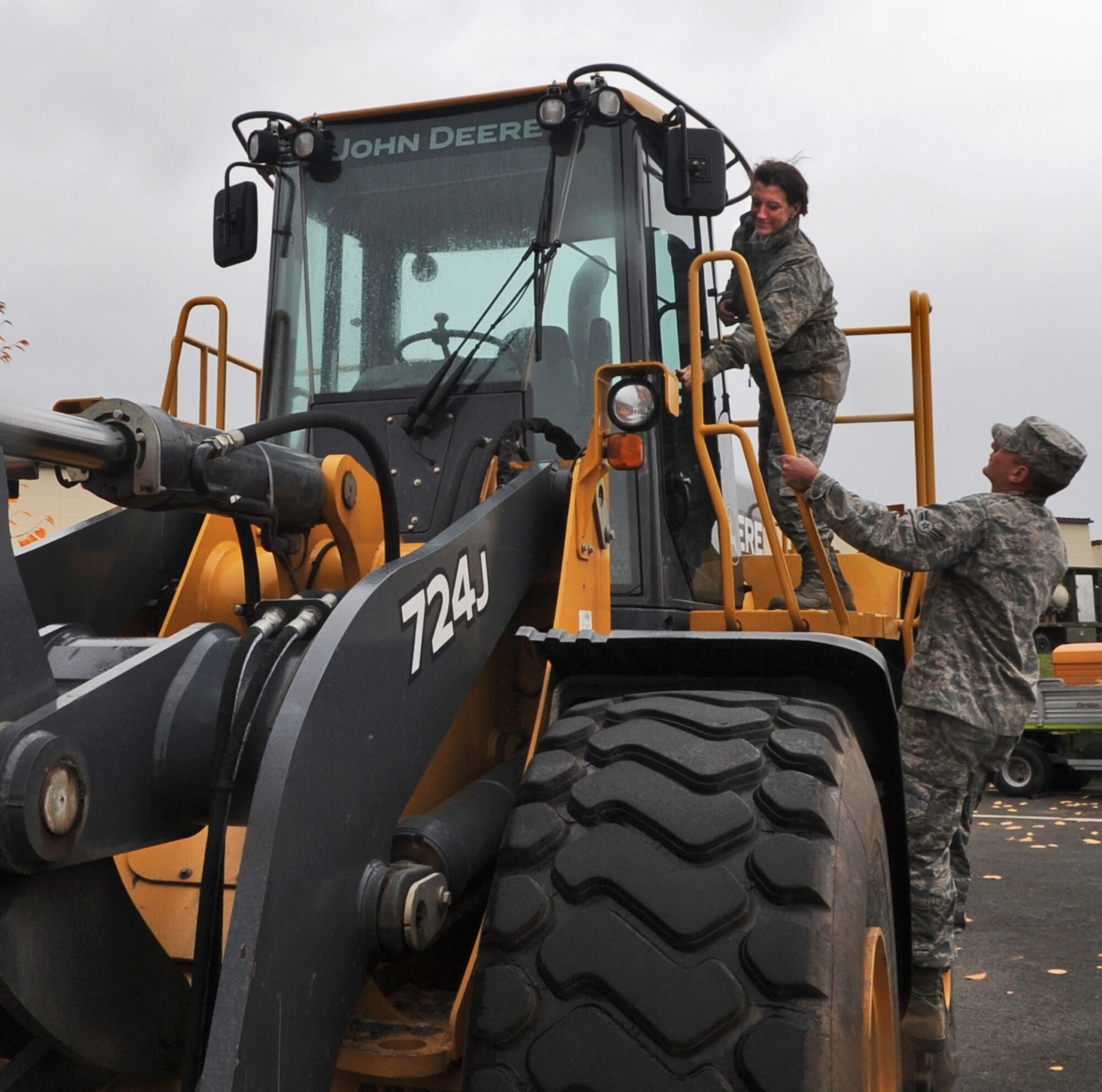 SPANGDAHLEM AIR BASE, Germany – Command Chief Master Sgt. Sandra Miller, 52nd Fighter Wing, climbs onto a front-end loader as Airman 1st Class Joshua Lemanski, 52nd Civil Engineer Squadron pavements and equipment apprentice stands by. During a snow removal demonstration Nov. 5., Chief Miller and other members of wing leadership learned about snow removal equipment and operations on base. (U.S. Air Force photo/Senior Airman Nick Wilson)