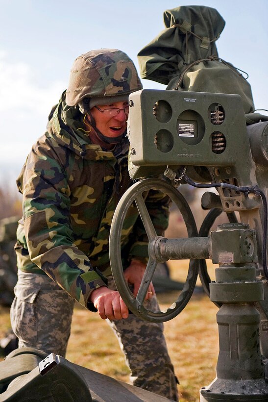 U.S. Army Sgt. Riley Bennett of Lebanon adjusts the orientation of an M777 Howitzer during a live-fire exercise on Camp Atterbury Joint Maneuver Training Center in central Indiana, Thursday, Nov. 4, 2010. Bennett is a field artilleryman assigned to 2nd Battalion, 150th Field Artillery Regiment, Indiana National Guard.