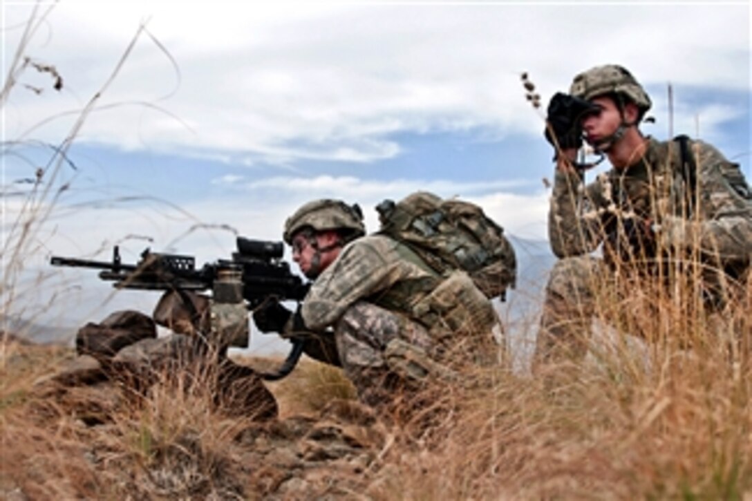 U.S. Army Spc. Joshua D. Heinbuch (left) and Spc. James M. Piccolo (right) secure the area after finding an improvised explosive device on a road in the Shalay Valley in eastern Kunar province, Afghanistan, on Nov. 4, 2010.  Heinbuch and Piccolo are assigned to the 101st Airborne Division's Company C, 2nd Battalion, 327th Infantry Regiment.  