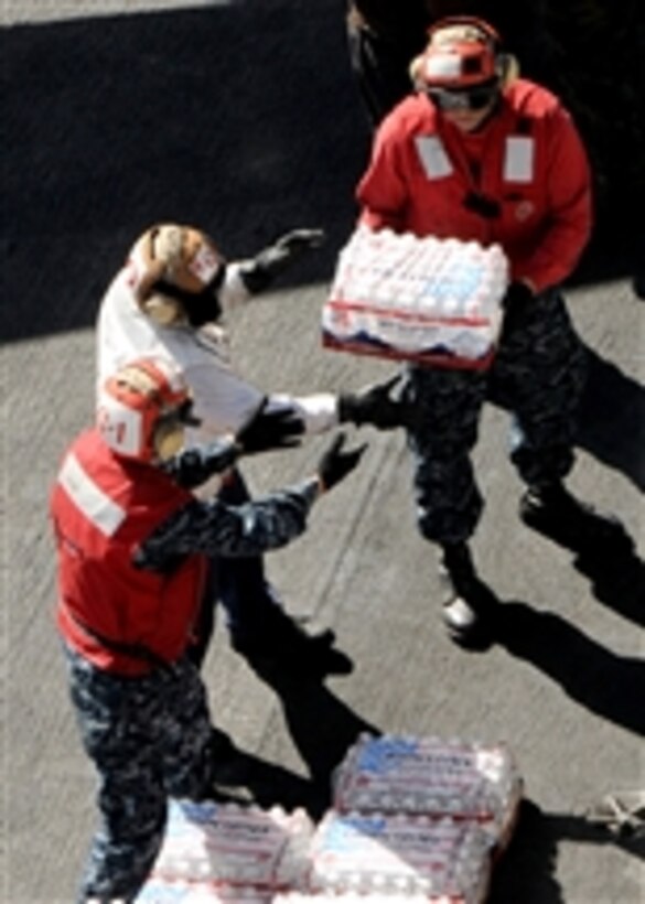 U.S. Navy sailors assigned to the aircraft carrier USS Ronald Reagan (CVN 76) and embarked Carrier Air Wing 14 form a daisy chain to unload cases of water from a C-2A Greyhound assigned to Fleet Logistics Combat Support Squadron 30 on Nov. 9, 2010.  The Ronald Reagan was diverted from its current training maneuvers at the direction of Commander U.S. Third Fleet and at the request of the U.S. Coast Guard to a position south near the Carnival cruise ship to facilitate the delivery of 4,500 pounds of supplies to the cruise ship.  Early Monday CV Splendor reported it was dead in the water 150 nautical miles southwest of San Diego.  
