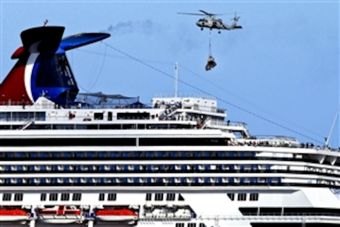 An HH-60H Seahawk helicopter embarked aboard the aircraft carrier USS Ronald Reagan delivers pallets of supplies to the Carnival cruise ship C/V Splendor in the Pacific Ocean, Nov. 9, 2010. At the request of the U.S. Coast Guard, the Ronald Reagan was diverted from its training maneuvers to help deliver 4,500 pounds of supplies to the ship.