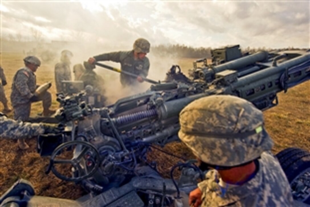 U.S. Indiana National Guard soldiers work together to smoothly execute a fire mission using an M777 Howitzer on Camp Atterbury Joint Maneuver Training Center in central Indiana, Nov. 4, 2010. The Indiana Guard is one of the first states to receive this piece of equipment. The soldiers are assigned to 2nd Battalion, 150th Field Artillery Regiment.