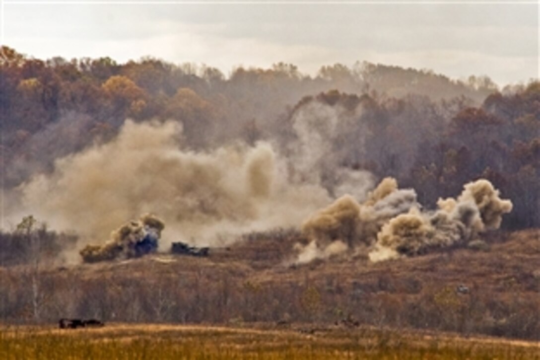 U.S. Army soldiers fire a barrage of 155mm artillery rounds from M777 Howitzers on Camp Atterbury Joint Maneuver Training Center in central Indiana, Nov. 5, 2010. The soldiers are assigned to the 2nd Battalion, 150th Field Artillery Regiment, Indiana National Guard, which recently received the equipment. The rounds weigh about 100 pounds and have a casualty radius of 100 meters.