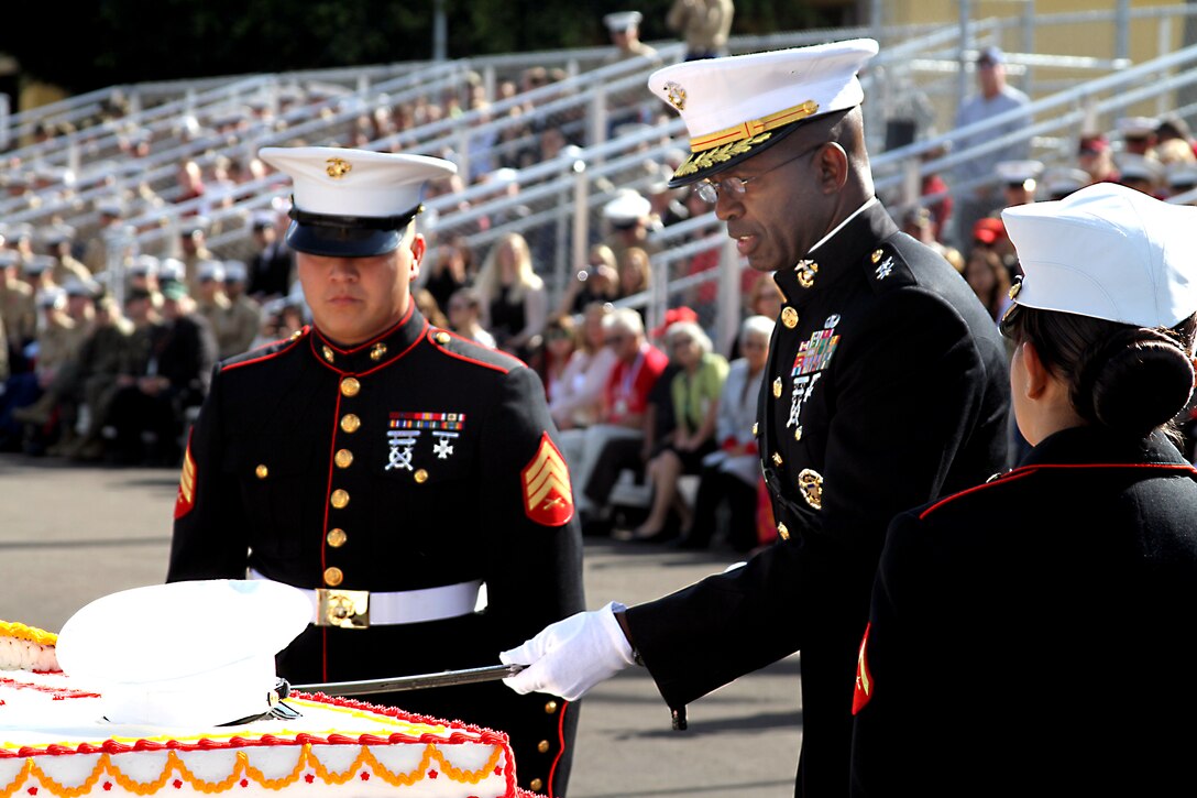 Maj. Gen. Ronald L. Bailey, cuts the traditional cake as cake escort, Sgt. Francisco R. Castro  looks on. The depot celebrated the 235th birthday of the United States Marine Corps, Nov. 10, during the Cake Cutting Ceremony and Uniform Pageant on the depot’s Shepherd Memorial Drill Field.  Bailey is the commanding general, Marine Corps Recruit Depot San Diego and the Western Recruiting Region, and Castro is a drill instructor, Company M.
