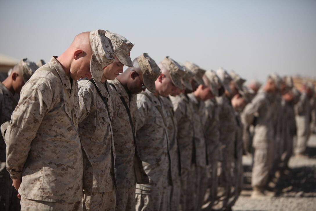 Marines from 1st Marine Logistics Group (Forward) bow their heads as they pray during a traditional cake-cutting ceremony held in honor of the United States Marine Corps' 235th birthday at Camp Leatherneck, Afghanistan, Nov. 10. More than 300 Marines celebrated with a reading of Gen. John A. Lejeune's birthday message, a message from the Commandant of the Marine Corps and a formal cake-cutting ceremony.