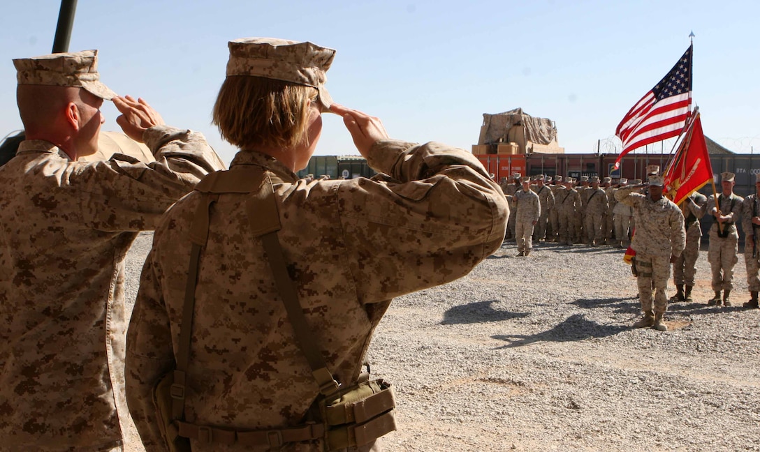 Members of Combat Logistics Battalion 3, 1st Marine Logistics Group (Forward), render salutes while the National Anthem plays during a ceremony celebrating the Marine Corps’ 235th birthday on Camp Dwyer, Afghanistan, Nov. 10.