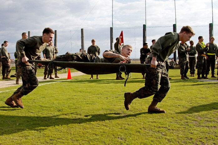 Marines race through the casualty relay competition during the annual Marine Aircraft Group 12 field meet at the Penny Lake fields here Nov. 10. Other events included during the competition were soccer, ultimate Frisbee, tug-of-war and more.