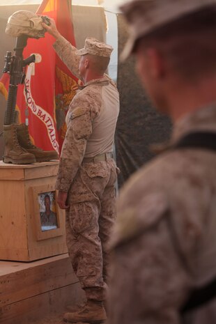 Sgt. Maj. Bryan Zickefoose, the sergeant major of Regimental Combat Team 1, pays respects to 1st Lt. James Zimmerman, formerly the commander of 3rd Platoon, Echo Company, 2nd Battalion, 6th Marine Regiment, during Zimmerman's memorial service at Patrol Base Shanfield, Helmand province, Afghanistan, Nov. 11. Zimmerman was from Aroostock, Maine.