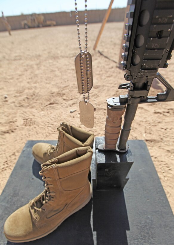 The identification tags of Lance Cpl. Terry E. Honeycutt Jr., a machine-gunner with Fox Company, 2nd Battalion, 9th Marine Regiment, hang from a battlefield cross display during a memorial service at a Marine Corps Base in Helmand Province, Afghanistan, Nov. 11. Honeycutt gave the ultimate sacrifice, Oct. 27, while conducting combat operations in Northern Marjah.