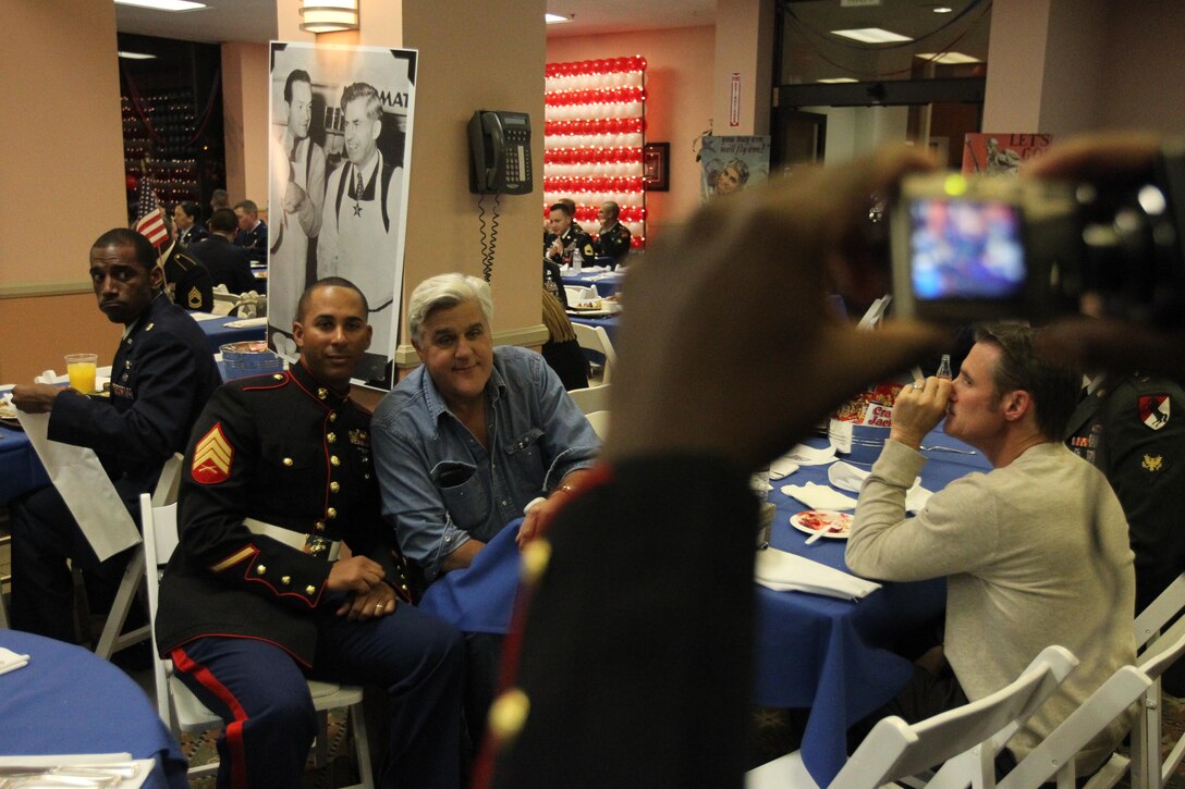 Jay Leno, an honorary Navy Petty Officer , poses for a photo with a Marine after the recording of Tonight Show with Jay Leno, featuring an all military audience Nov. 11.::r::::n::::r::::n::