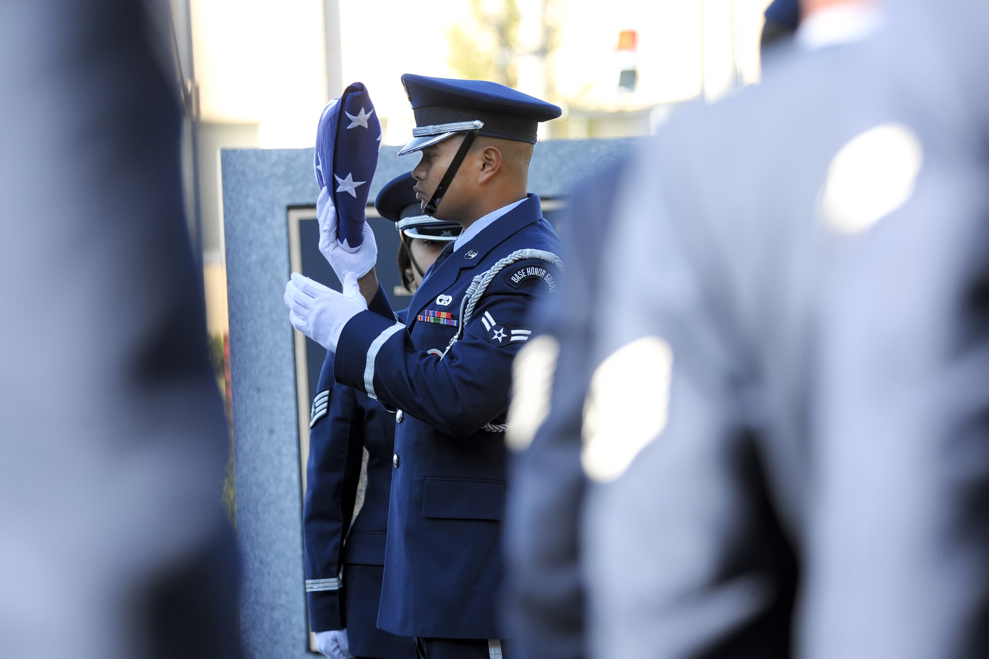 YOKOTA AIR BASE, Japan -- Airman 1st Class Christopher Sy, 374th Logistics Readiness Squadron performs the final steps of the flag folding ceremony.  Yokota Airmen, Boy Scouts, the Yokota chapter of the Veterans of Foreign Wars and American Legion Post 2222 participated in the 374th Airlift Wing's Veterans Day Ceremony.  (U.S. Air Force photo/Osakabe Yasuo)