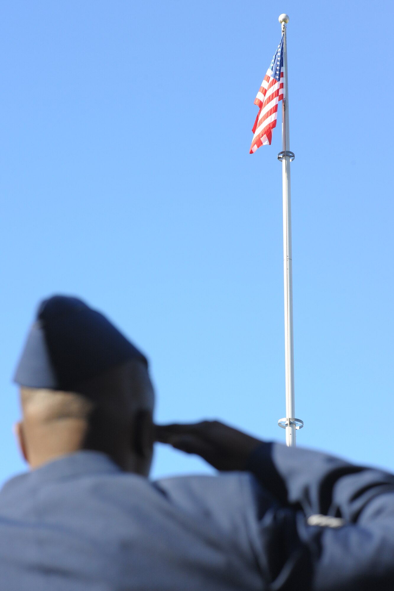 YOKOTA AIR BASE, Japan -- A Yokota Airman salutes the flag during the American national anthem here Nov. 11 during the 374th Airlift Wing Veterans Day ceremony. (U.S. Air Force photo/Osakabe Yasuo)