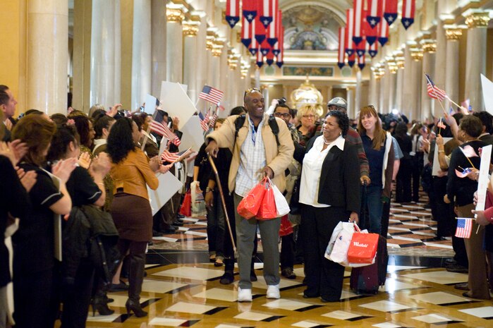 LAS VEGAS -- A wounded combat veteran and his family walk down the hall of The Venetian on Veteran's Day, Nov. 11, 2010, to begin their all expenses paid vacation weekend and are greeted by applause, cheering, and encouraging signs. This weekend getaway was planned by ThanksUSA, an organization created in an effort to thank the men and women of our armed forces and their families for their service to the country with scholarship programs and events like the "Tribute to the Troops." (U.S. Air Force Photo / Airman 1st Class Jamie Nicley)(Released)