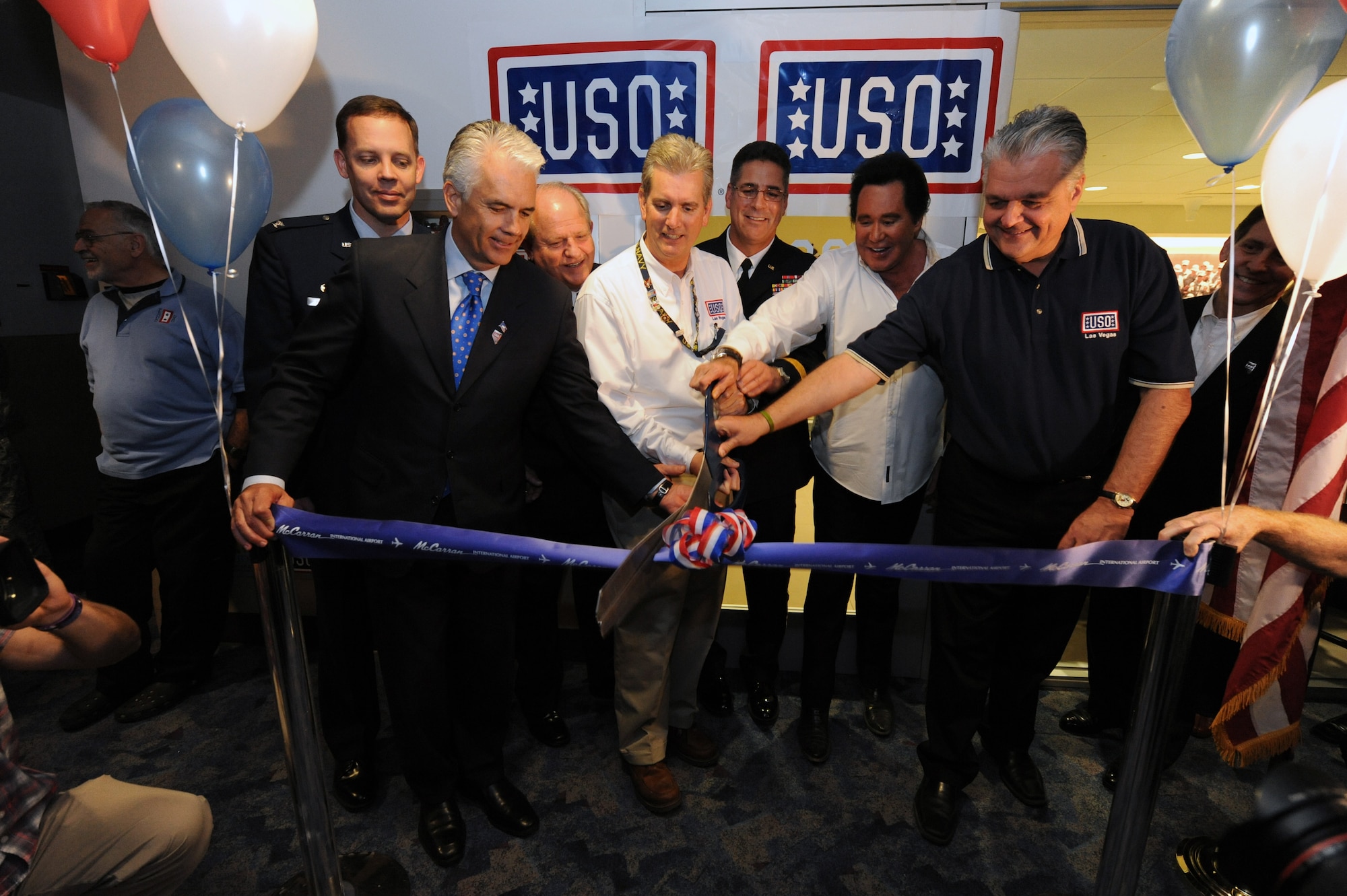 LAS VEGAS -- Distinguished guests and USO executives cut the ribbon at of the grand opening of the new USO at McCarran International Airport, Nov. 11. All branches of the U.S. military were in attendance of the grand opening. (U.S. Air Force Photo by Senior Airman Brett Clashman/Released)
