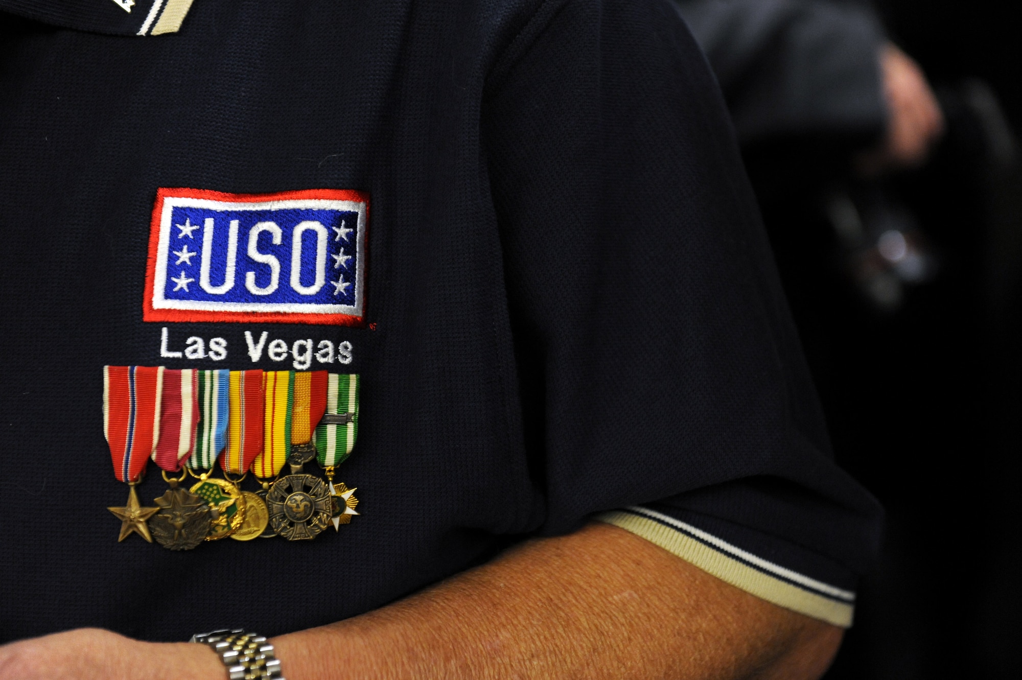 LAS VEGAS -- A USO volunteer and Veteran wears military decorations on his shirt during the USO grand opening at McCarran International Airport, Nov. 11. (U.S. Air Force Photo by Senior Airman Brett Clashman/Released)
