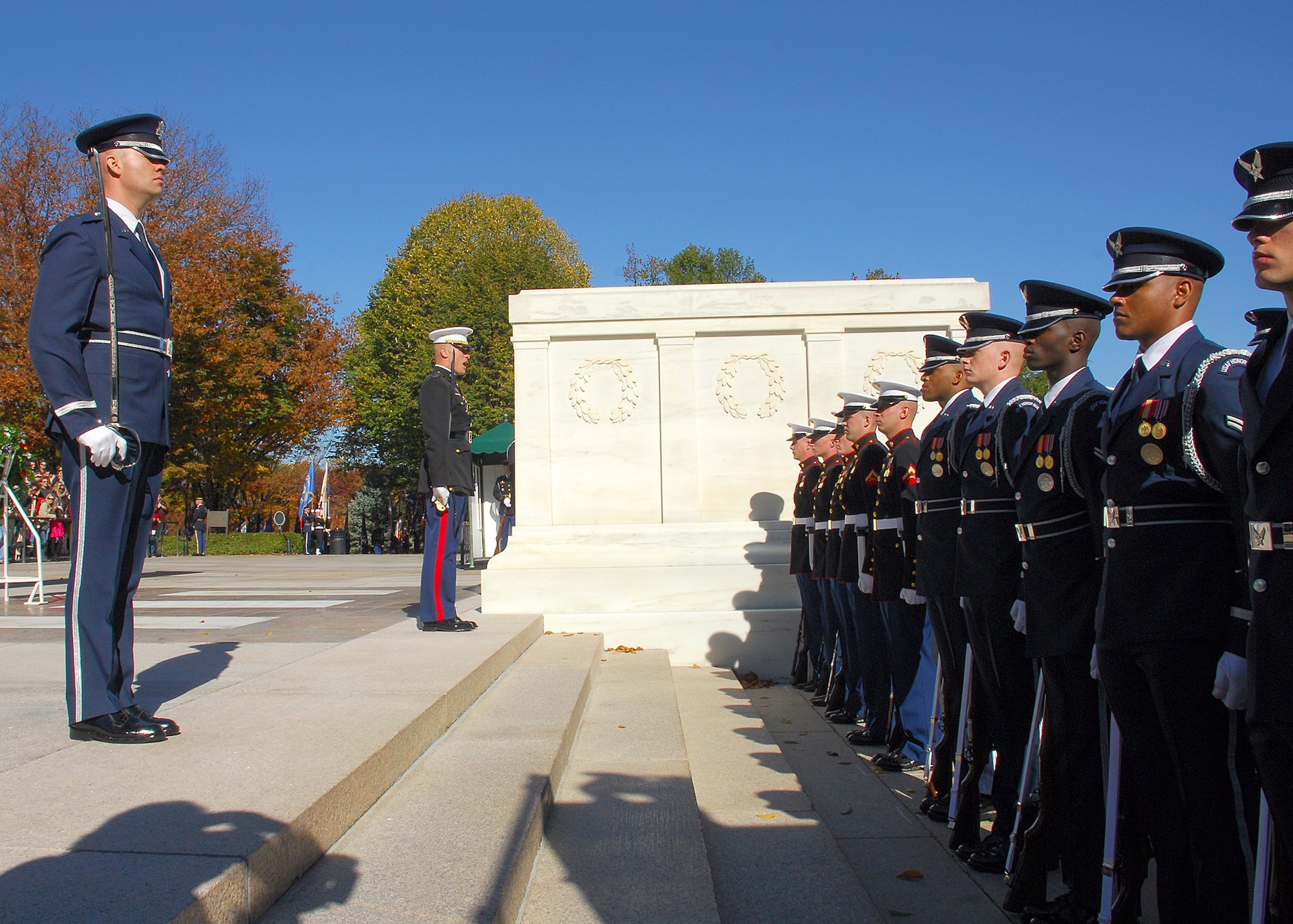 Members of the joint service honor guard stand in formation for the wreath-laying presentation at the Tomb of the Unknowns Nov. 11, 2010, during the Veterans Day ceremony at Arlington National Cemetery in Arlington, Va. Many senior Department of Defense leaders attended the event along with hundreds of visitors and veterans. (U.S. Air Force photo/Master Sgt. Raheem Moore)
