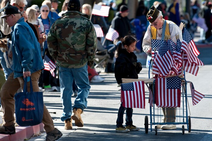 LAS VEGAS -- World War II veteran 86-year-old Pat Ansbury sells American flags during the Las Vegas Veterans Day Parade Nov. 11, 2010. Airmen from the U.S. Air Force Honor Guard and Nellis Air Force Base participated in the parade.  (U.S. Air Force photo / Tech. Sgt. Michael R. Holzworth)(Released)