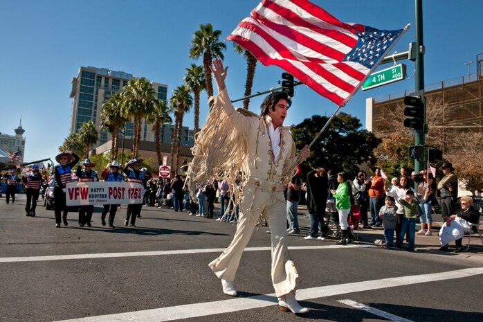 LAS VEGAS -- An Elvis impersonator waives an American flag and marches in the Las Vegas Veterans Day Parade Nov. 11, 2010. Airmen from the U.S. Air Force Honor Guard and Nellis Air Force Base participated in the parade.  (U.S. Air Force photo / Tech. Sgt. Michael R. Holzworth)(Released)
