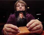 SEYMOUR JOHNSON AFB, N.C. -- Janet Monti holds up a picture of Jared inside the 333rd Fighter Squadron lounge Tuesday evening. The following day the mother took flight in honor of her son.  (Courtesy photo/News-Argus/Michael Betts)