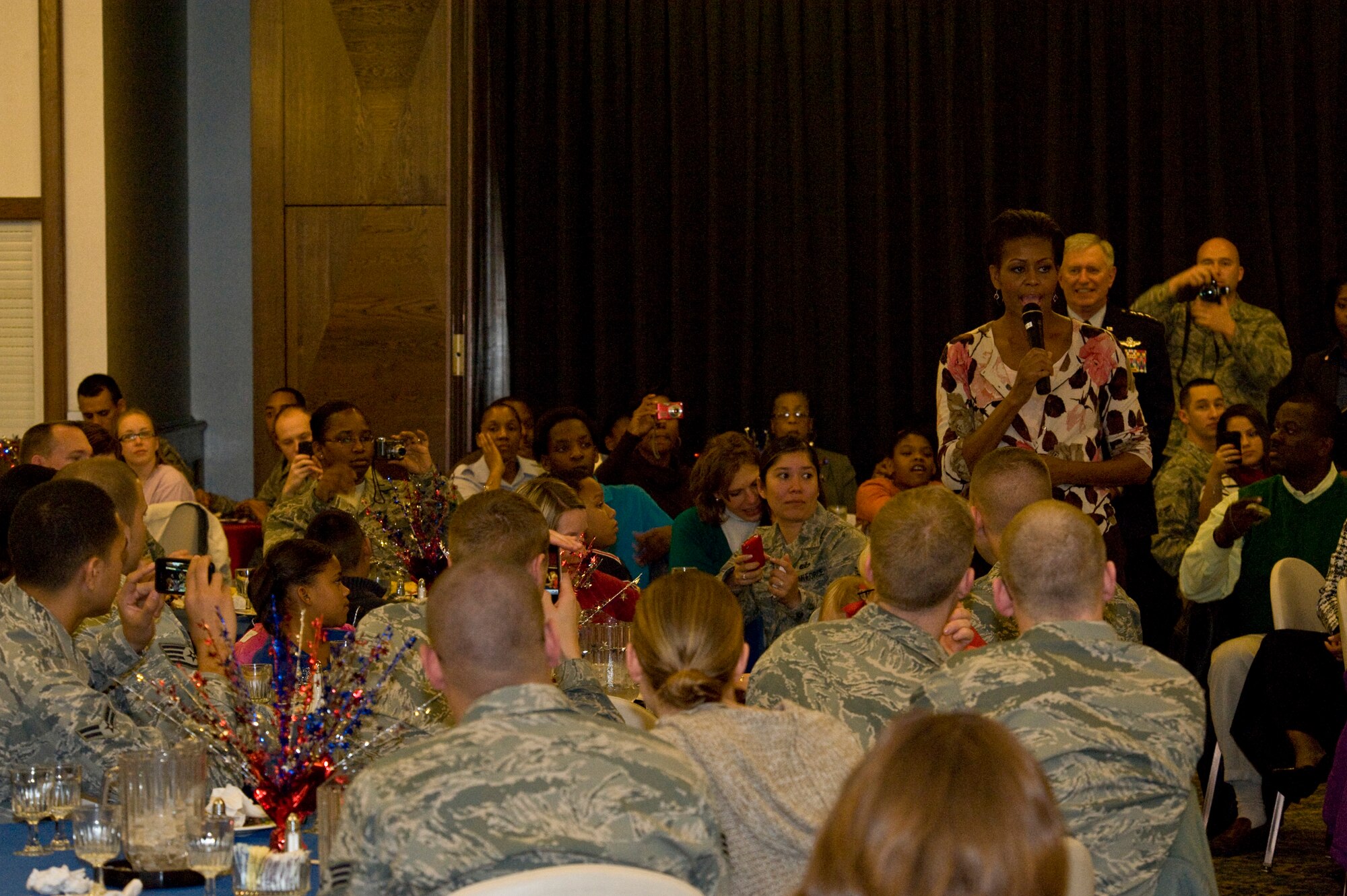 First Lady Michelle Obama talks with servicemembers and their families during a Veterans Day dinner at the Officers Club on Ramstein Air Base, Germany, Nov. 11, 2010. The First Lady made a surprise visit to Ramstein during her return from a nine-day tour of Asia to show her support for servicemembers and their families during this Veterans Day. She met with wounded servicemembers at Landstuhl Regional Medical Center, served lunch, talked briefly to the servicemembers and families and met with German first lady Bettina Wulff before flying on to the United States. (U.S. Air Force photo/Tech Sgt. Wayne Clark) 