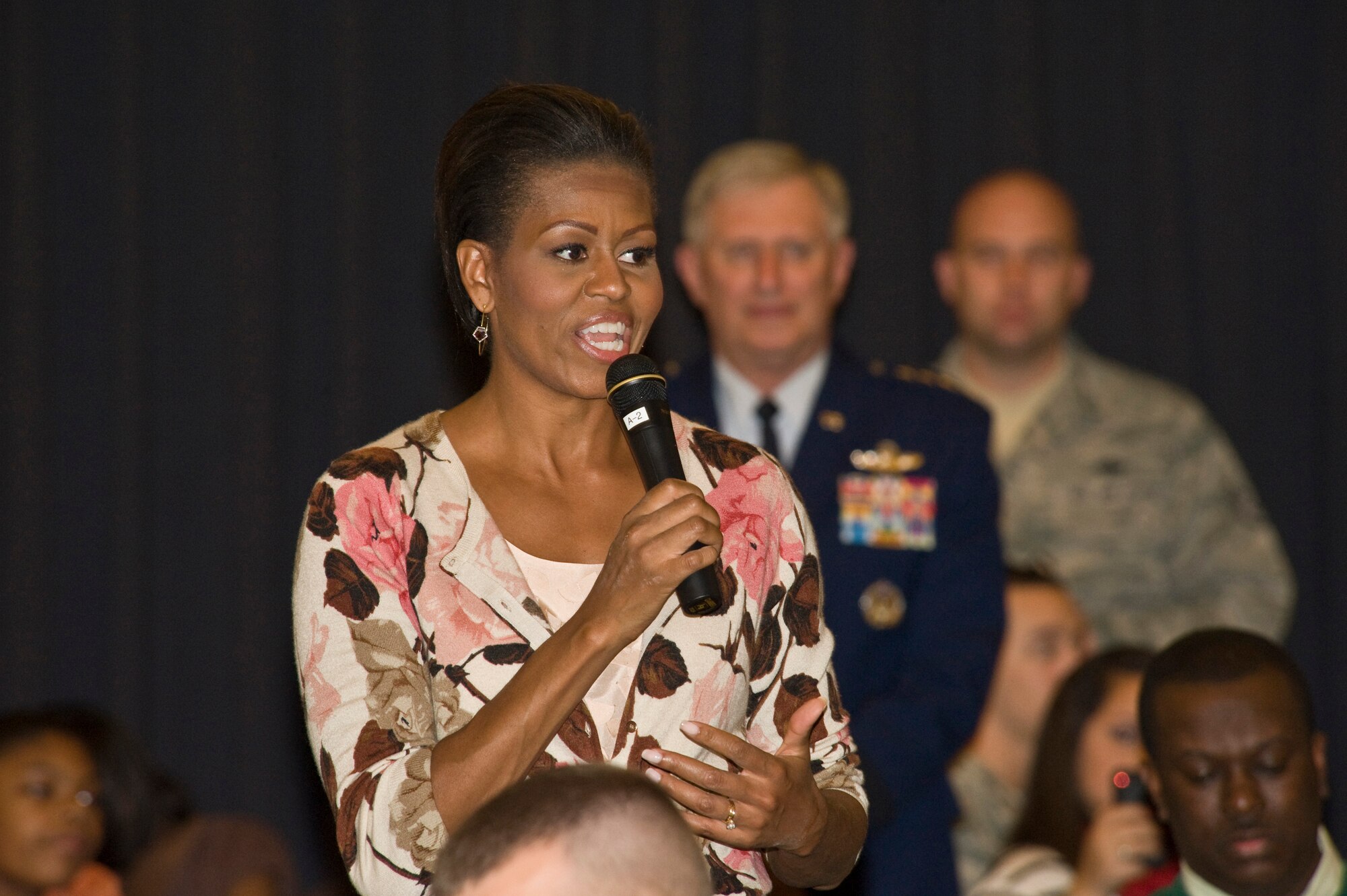 First Lady Michelle Obama talks to servicemembers and their families during a Veterans Day dinner at the Officers Club on Ramstein Air Base, Germany, Nov. 11, 2010. The First Lady made a surprise visit to Ramstein during her return from a nine-day tour of Asia to show her support for servicemembers and their families during this Veterans Day. She met with wounded servicemembers at Landstuhl Regional Medical Center, served lunch, talked briefly to the servicemembers and families and met with German first lady Bettina Wulff before flying on to the United States.  (U.S. Air Force photo/Tech. Sgt. Wayne Clark) 