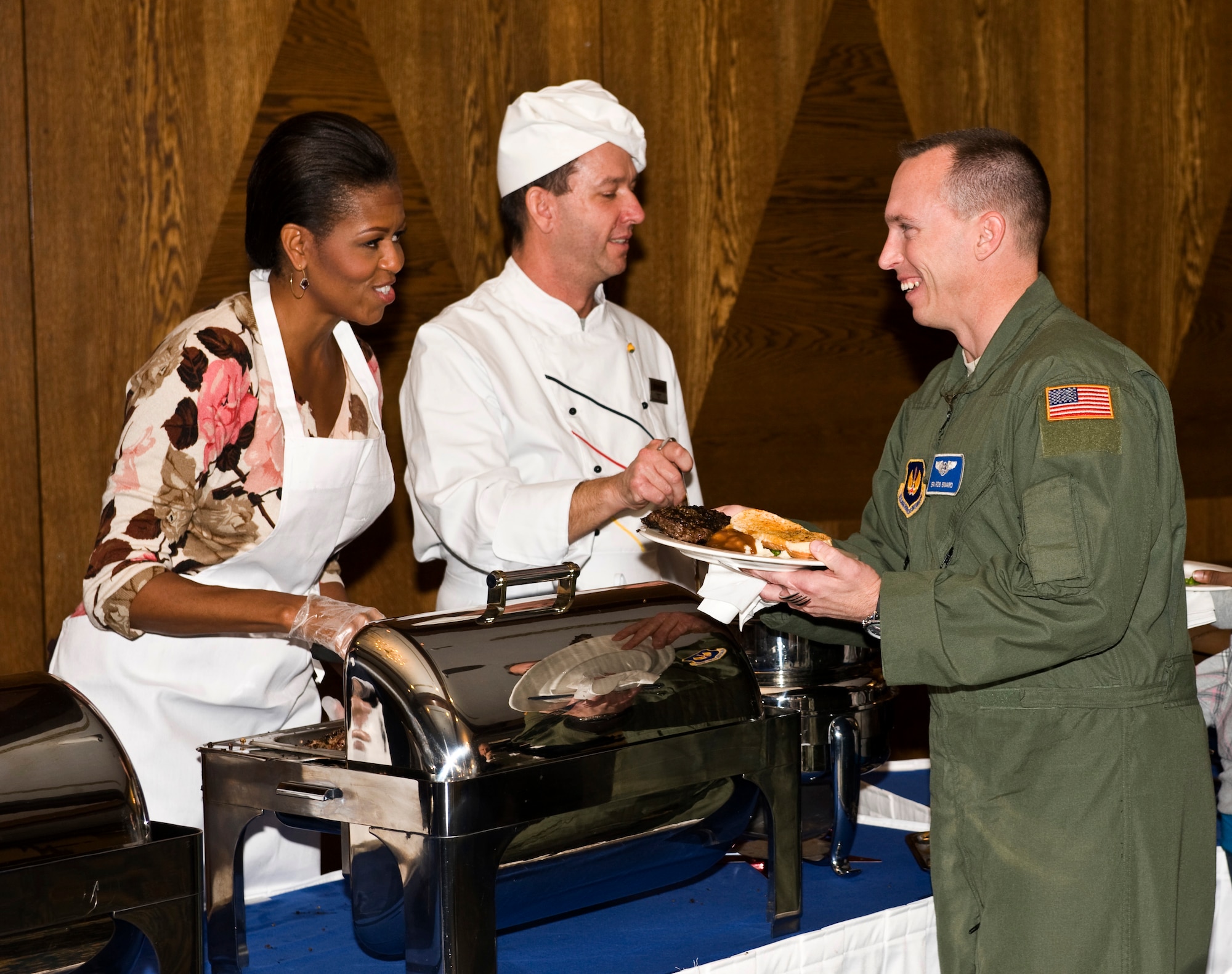 First Lady Michelle Obama talks with Senior Airman Rob Binard, 86th Aeromedical Evacuation Squadron, during a Veterans Day dinner at the Ramstein Air Base, Germany, Officers Club, Nov. 11, 2010. The First Lady made a surprise visit to Ramstein during her return from a nine-day tour of Asia to show her support for servicemembers and their families during this Veterans Day. She met with wounded servicemembers at Landstuhl Regional Medical Center, served lunch, talked briefly to the servicemembers and families and met with German first lady Bettina Wulff before flying on to the United States. (U.S. Air Force photo/Tech. Sgt. Wayne Clark) 