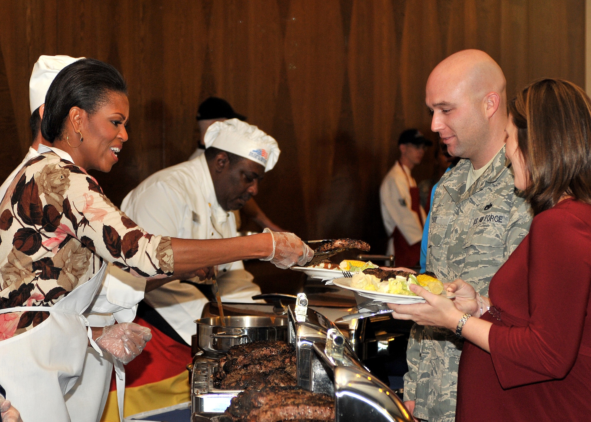 U.S. First Lady Michelle Obama, serves steaks to servicemembers and their families during a surprise visit to the Ramstein Officers Club Nov 11. Mrs. Obama met with wounded servicemembers at Landstuhl Regional Medical Center, served lunch, talked briefly to the servicemembers and families and met with German first lady Bettina Wulff before flying on to the United States. (U.S. Air Force Photo by Tech Sgt. Markus M. Maier)
