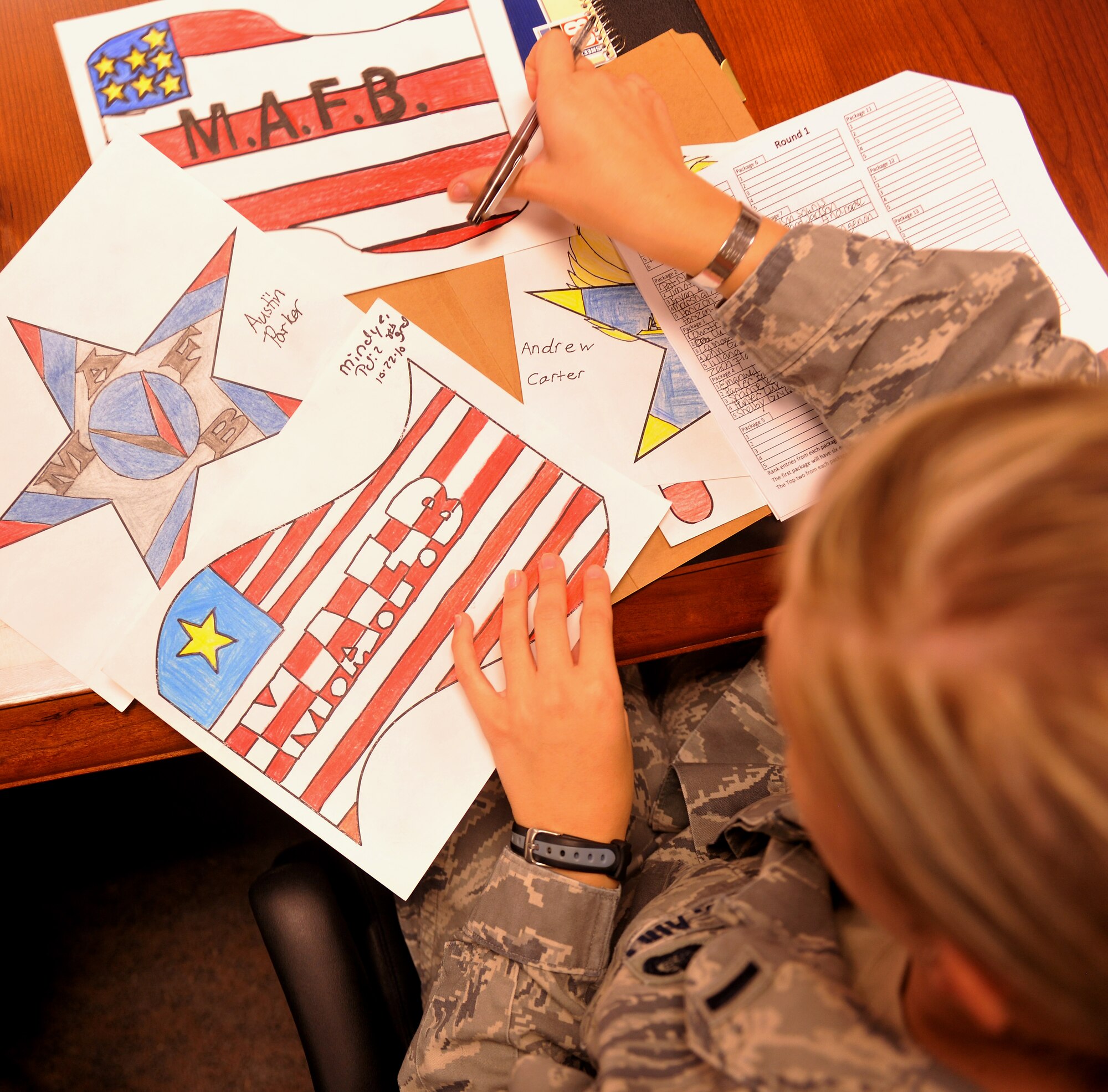 MOODY AIR FORCE BASE, Ga. -- Four posters lay scattered out during a judging session for the winner of the Airshow LOGO CONTEST here Nov. 9. The judging panel was made up of 14 Airmen from different base agencies and took about two hours to judge. (U.S. Air Force photo/Airman 1st Class Joshua Green)(RELEASED)
