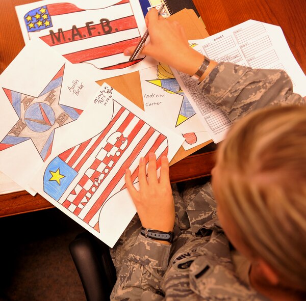 MOODY AIR FORCE BASE, Ga. -- Four posters lay scattered out during a judging session for the winner of the Airshow LOGO CONTEST here Nov. 9. The judging panel was made up of 14 Airmen from different base agencies and took about two hours to judge. (U.S. Air Force photo/Airman 1st Class Joshua Green)(RELEASED)
