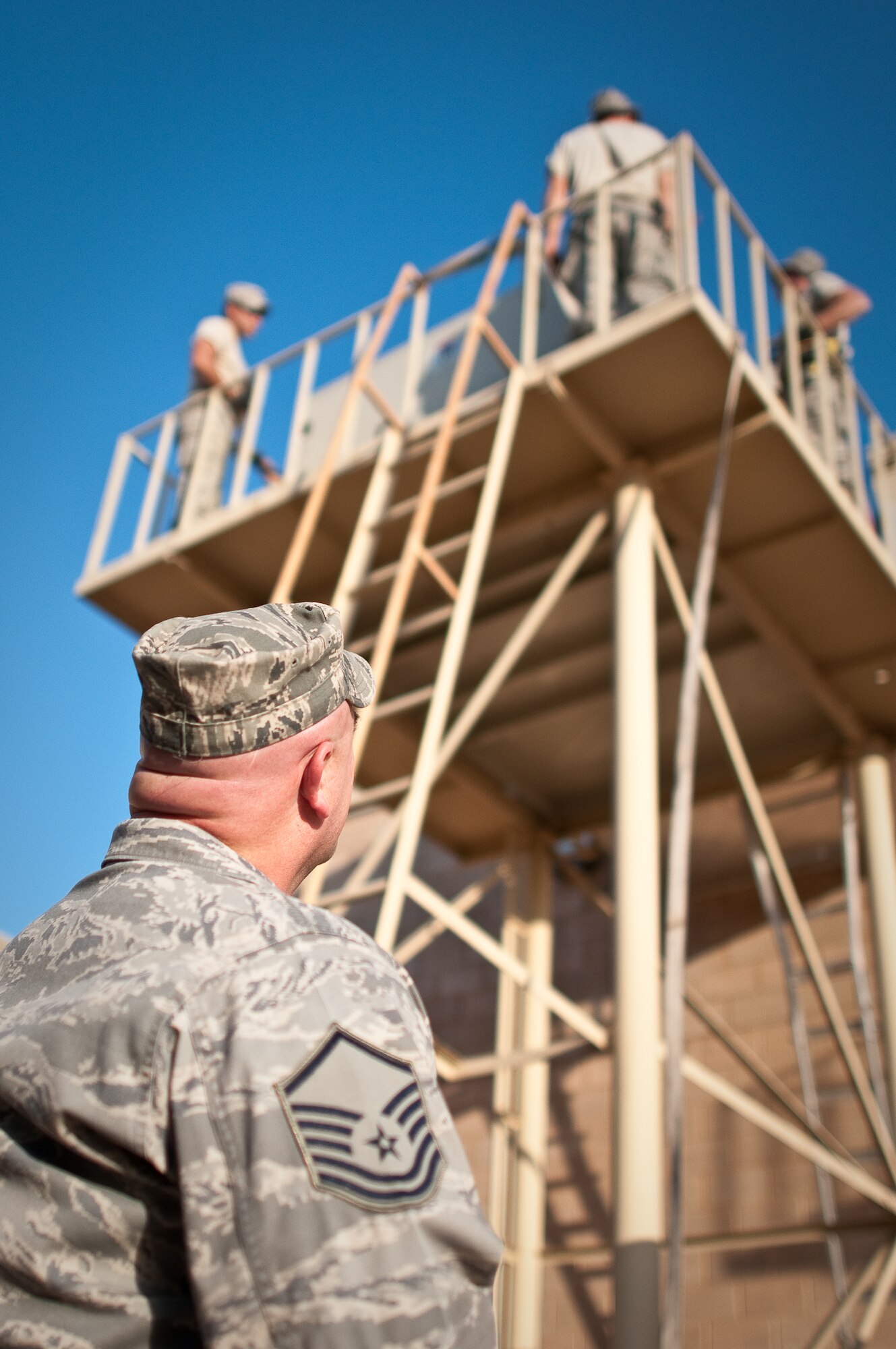SOUTHWEST ASIA - Master Sgt. Fred Lawrence, a ground safety technician with the 386th Air Expeditionary Wing, conducts a worksite safety inspection Nov. 11, 2010, as civil engineers repair an air conditioning unit at an undisclosed air base in Southwest Asia. Many safety mishaps could be prevented if Airmen would follow a simple, three-step process to assess potential dangers, officials say. (U.S. Air Force photo by Maj. Dale Greer/Released)
