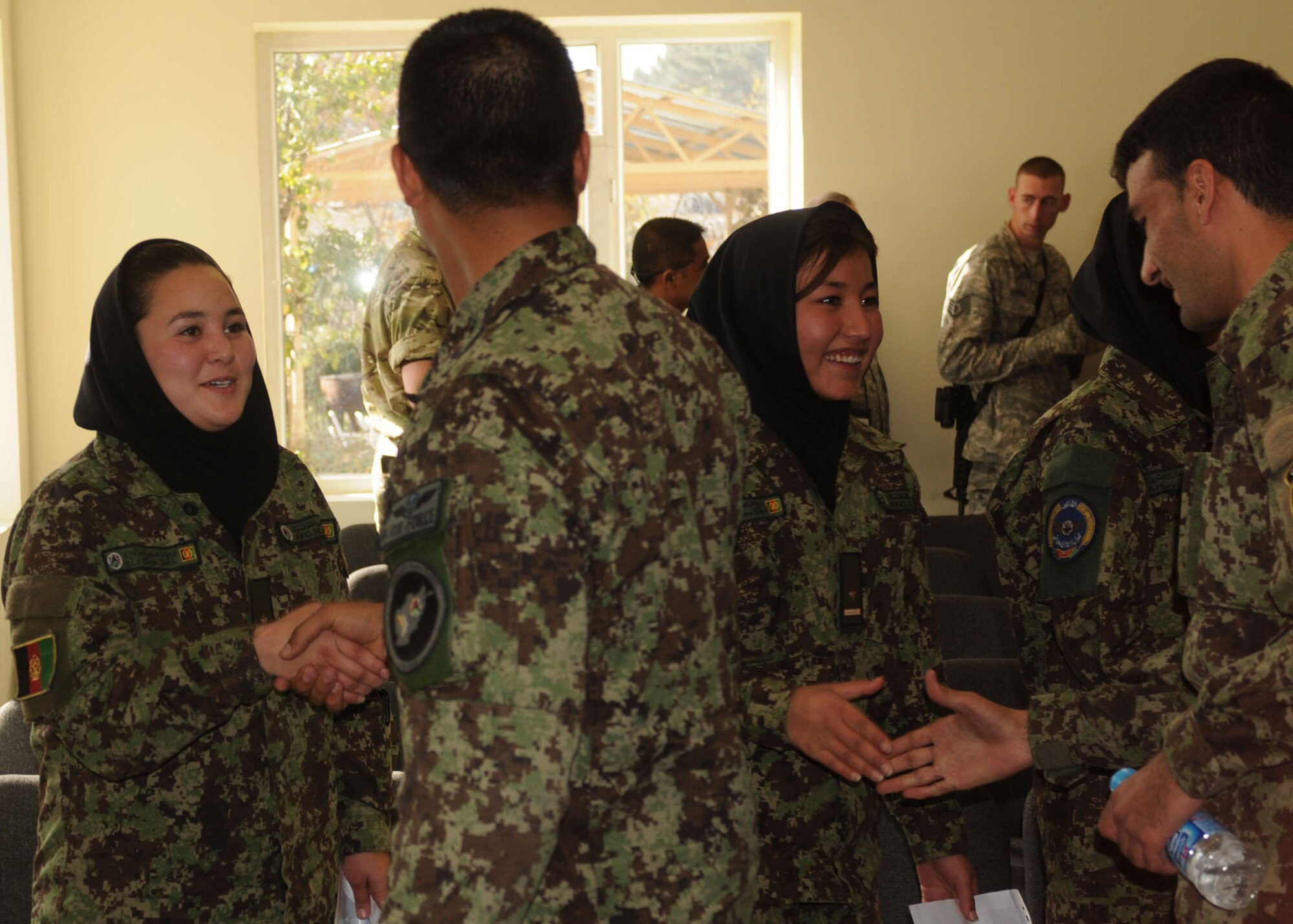 101106-N-6541W-017 KABUL, Afghanistan - Males from the Thunder Lab, located at Kabul's Air Force base English immersion training center, congratulate the female lieutenants on their graduation from the Air Orientation Course. Graduation from this course is the females first step to service in the AAF.  (U.S. Navy photo by Mass Communication Specialist 3rd Class Jared Walker/ RELEASED).