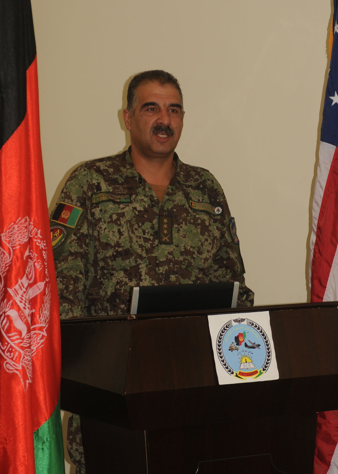 101106-N-6541W-002 KABUL, Afghanistan - Col. Mohammed Marif, Commander of the Pohantoon-e-Hawayee, The Afghan's Air Force's "Big Air School" in Kabul, Afghanistan speaks at the graduation of the first five female lieutenants from the Air Orientation Course. Graduation from this course is the females first step to service in the AAF.  (U.S. Navy photo by Mass Communication Specialist 3rd Class Jared Walker/ RELEASED).