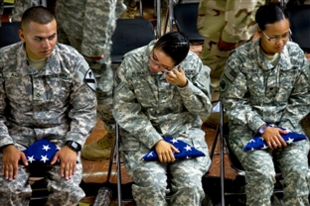 U.S. Army Pfc. Yiraldy Aloma, a native of Panama City, Panama, wipes a tear from her eye after becoming a U.S. citizen during a naturalization ceremony sponsored by U.S. Forces-Iraq at Al Faw Palace on Camp Victory, Iraq, Nov. 11, 2010. During the ceremony, 50 troops took the oath of allegiance.