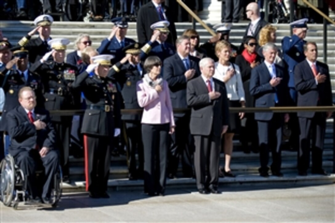 Defense Secretary Robert M. Gates; Marine Corps Gen. James Cartwright, vice chairman of the Joint Chiefs of Staff; and other senior defense officials render honors during the playing of the national anthem as part of a Veterans Day ceremony at the Tomb of the Unknowns at Arlington National Cemetery in Arlington, Va., Nov. 11, 2010.