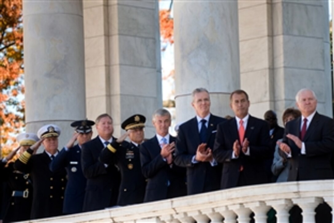 Defense Secretary Robert M. Gates, right, Representative John A. Boehner, R-Ohio, second from right, and other defense offiicals render honors during a Veterans Day ceremony at Arlington National Cemetery in Arlington, Va., Nov. 11, 2010.