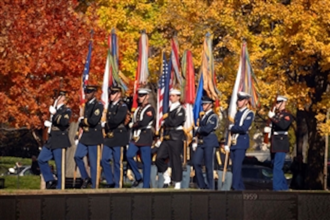 A U.S. military color guard from the Military District of Washington retires the colors at the Vietnam Veterans Memorial Veteran's Day observance at the National Mall, Washington, D.C., Nov. 11, 2010.