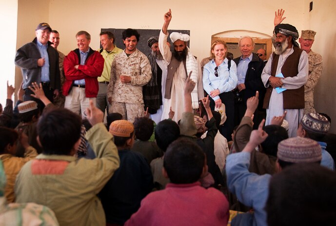 Children at Khalaj High School raise their hand after their teacher asked who wants to grow up to be a Marine during a visit from U.S. senators to Nawa, Afghanistan, Nov. 11, 2010. Senators John McCain, a senior senator from Arizona, Lindsey Graham, a senior senator from South Carolina, Kirsten Gillibrand, a junior senator from New York, and Joseph I. Lieberman, a junior senator from Connecticut, visited Marines of 3rd Battalion, 3rd Marine Regiment, where they toured Khalaj High School, the Nawa District bazaar and the Nawa District Governance Center as well as meeting with Nawa government officials.