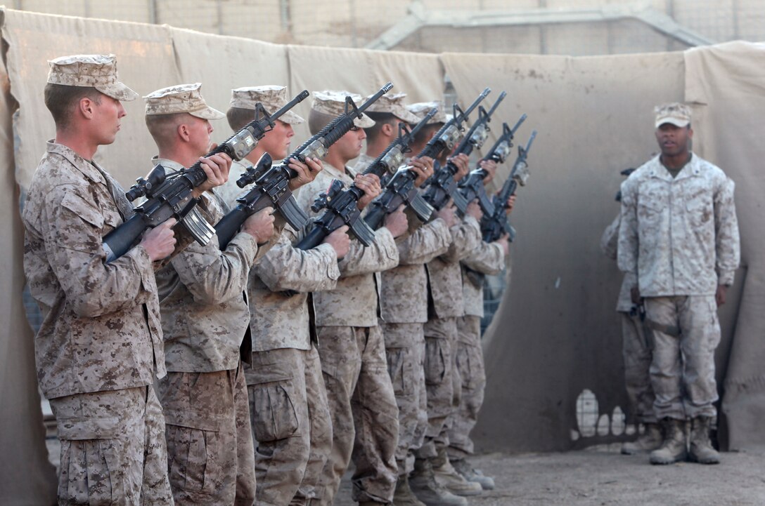 A rifle detail with Echo Company, 2nd Battalion, 6th Marine Regiment renders a final, honorable farewell to 1st Lt. James Zimmerman, formerly the commander of the company's 3rd Platoon, during his memorial service at Patrol Base Shanfield, Helmand province, Afghanistan, Nov. 11. Zimmerman was from Aroostock, Maine.