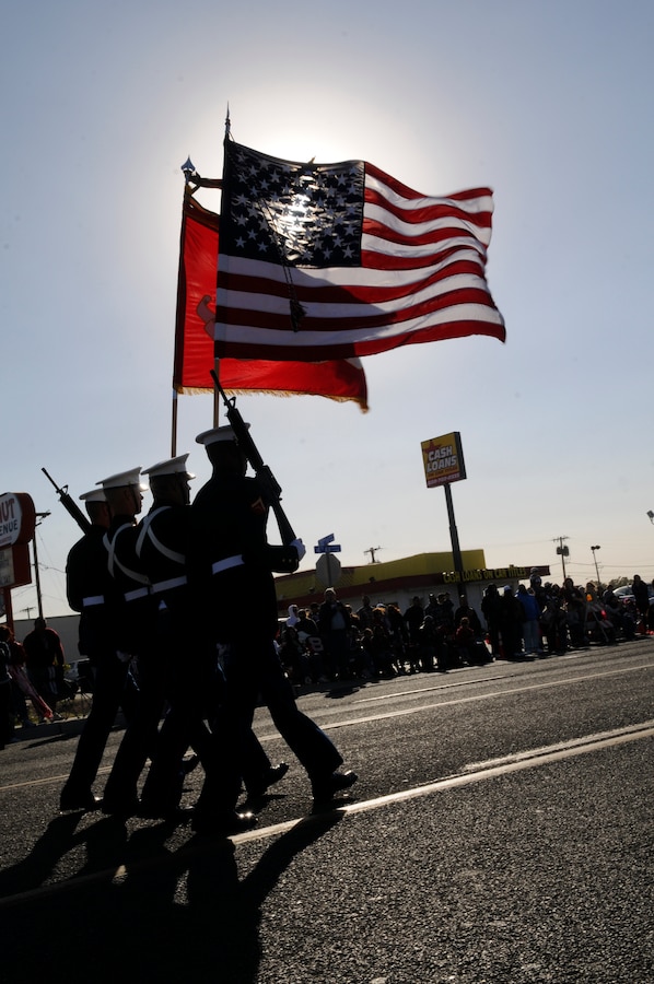 Marines with Combat Logistics Company 16 carry the U.S. and Marine Corps colors while marching down 4th avenue in Yuma, Ariz., Nov. 11, 2010, commemorating Veterans Day. “It’s pretty cool being able to be the color guard during the parade,” said Lance Cpl. Nick Kowalewski, CLC-16 generator mechanic and member of the color guard. “It’s an honor celebrating the service of military personnel on this day.”