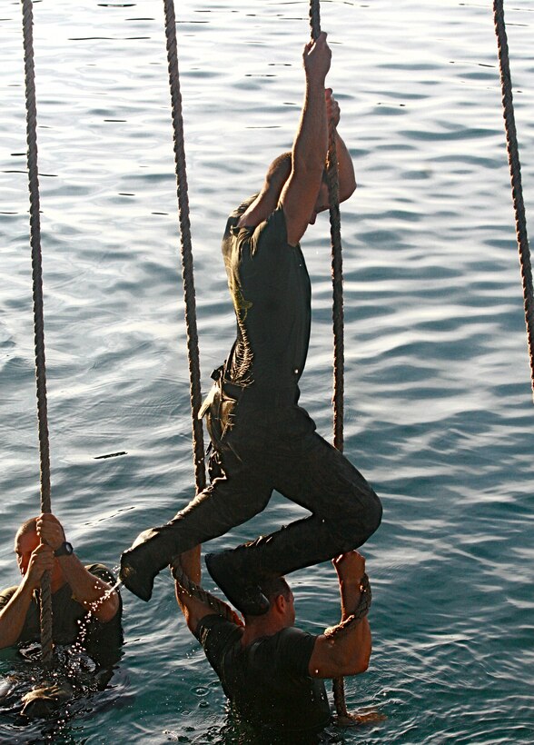 Marines of 2nd Platoon, Force Reconnaissance Company, II Marine Expeditionary Force, navigate through the Dutch Water Obstacle Course Nov. 11, 2010. The Marines completed the water obstacle course as part of the Tri Deux Colours International Competition.